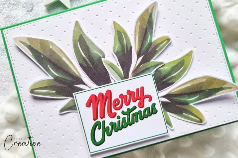 Handmade "Merry Christmas" card with greenery and embossed white background