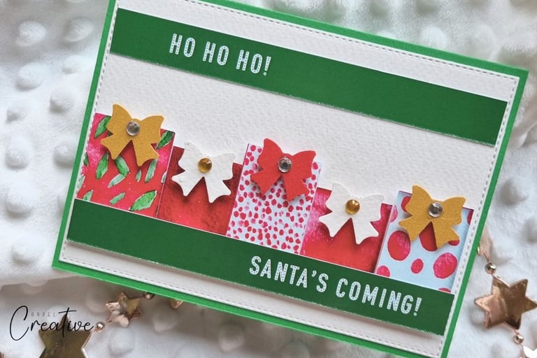 Handmade Christmas card with little gifts and "Santa's Coming" sentiment