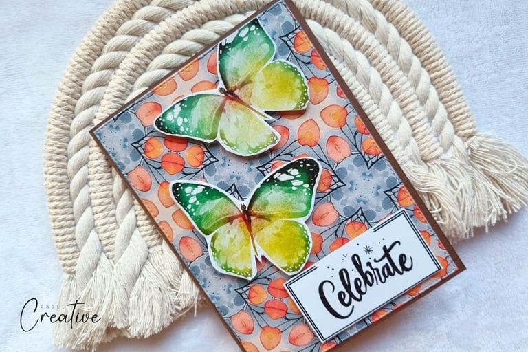 Handmade greeting card with fall colors background, two butterlies and a sentiment "Celebrate"