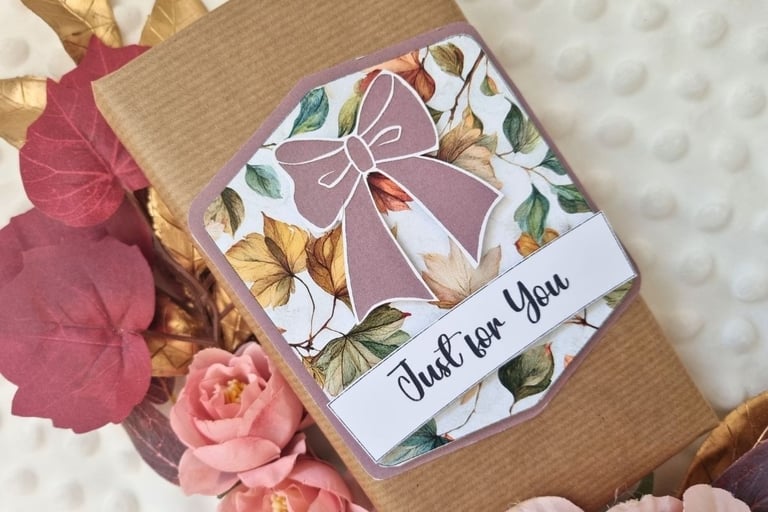 Handmade gift tag with purple ribbon and "just for you" sentiment on wrapped gift in brown paper.