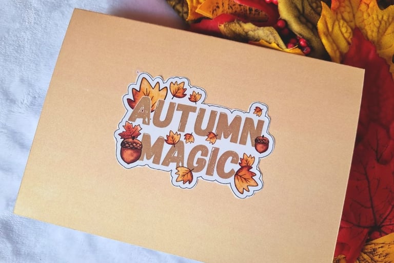Orange back of the card with a sticker on it saying "Autumn Magic"