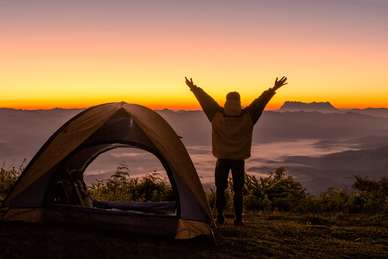 A person camping at sunset in Colorado, joyful about being free from chronic pain
