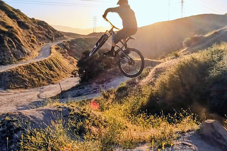 Mountain biker with clean jump form, relaxed knees and centered body