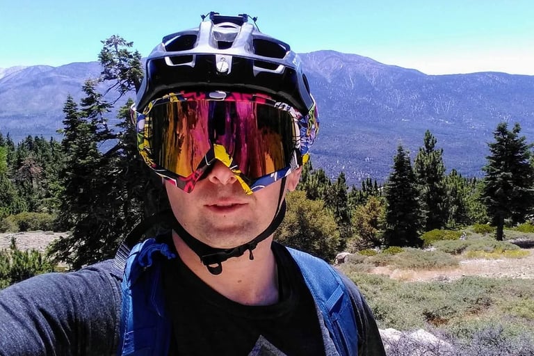 mountain biker with goggles over half shell helmet
