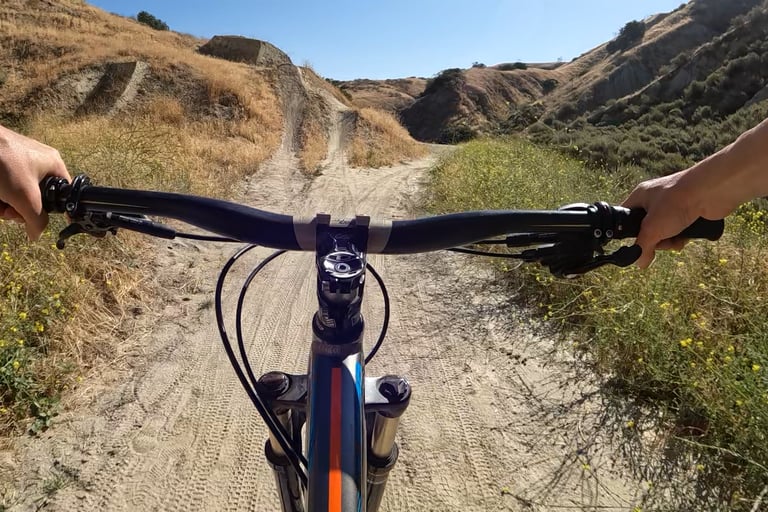 mountain bike pov of rider going up to jump