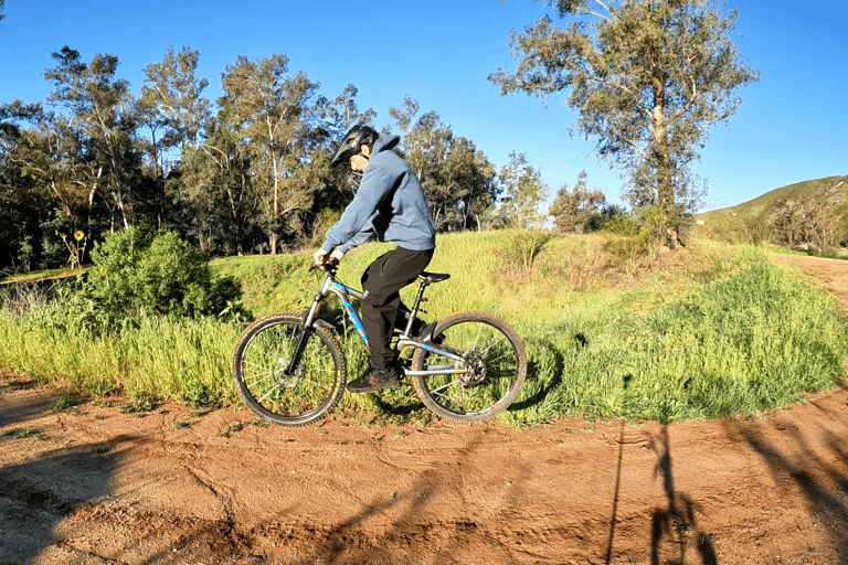 Mountain biker leveling the bike out on a j hop