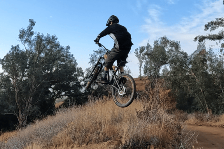 Proper neutral jump landing — rider level in the air with balanced body position and smooth bike ang