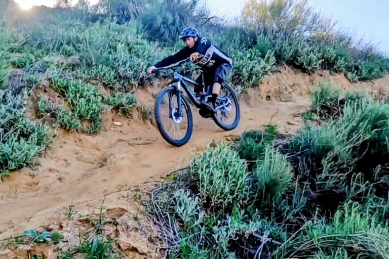 mountain biker showing how to ride steep trails on a mountain bike