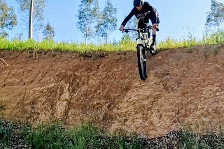 mtb rider just going over edge of steep drop in