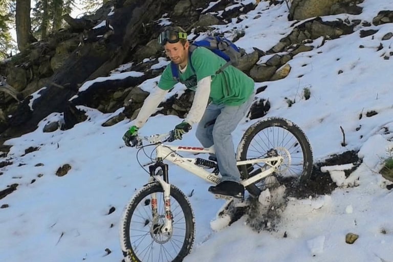 Mountain biker riding in snowy conditions in Southern California mountains