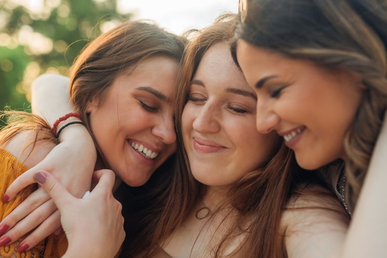 three girls are hugging their arms around each other