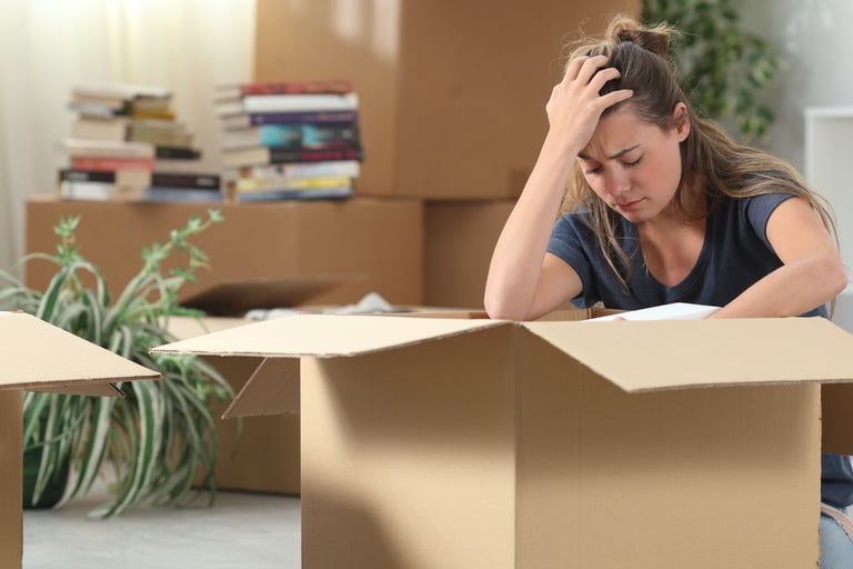 a woman sitting on the floor with a moving box