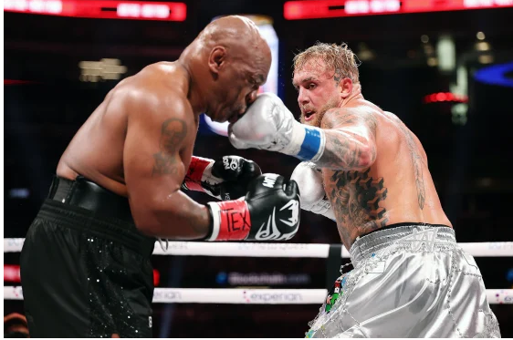 a man in a boxing ring with a referee fight