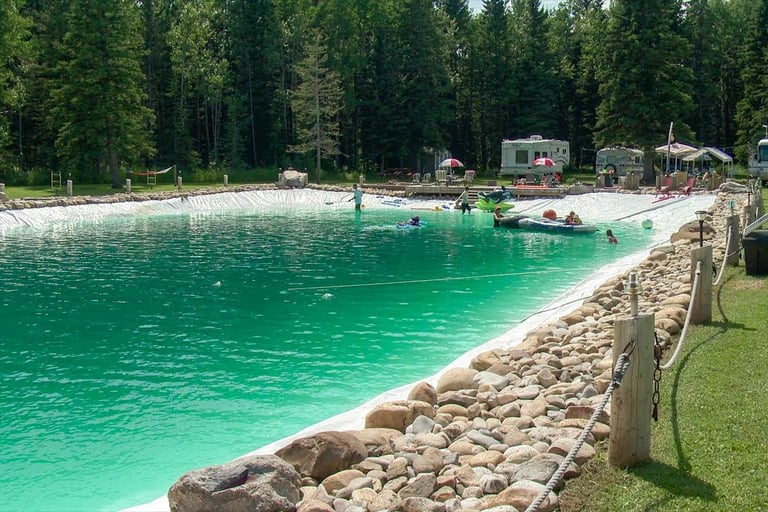 Emerald green natural swimming lake with chemical-free water & public access for rejuvenation & play
