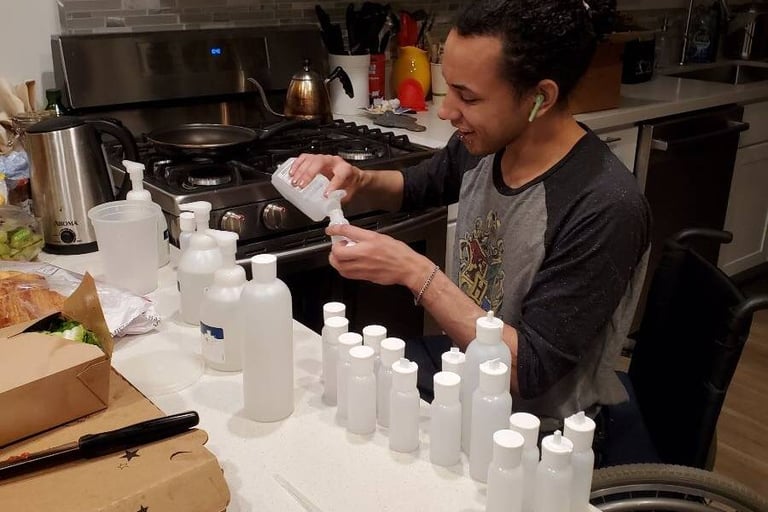 Photo. of Stacey's friend Charlie making home made wellness kits in the kitchen.