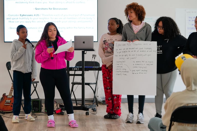 a group of people standing around a presentation