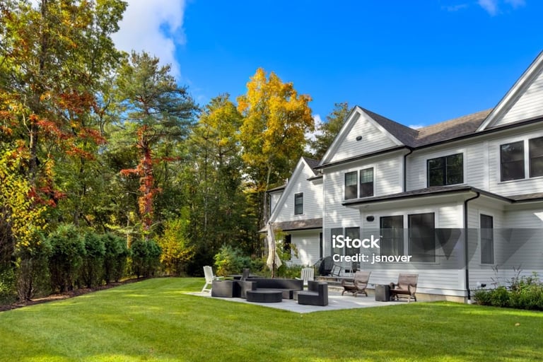 a large backyard with a fire pit and a patio