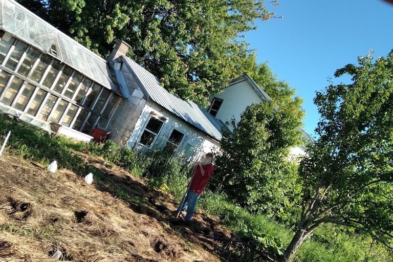 Farmer Brian stands in front of the solarium, one of our greenhouses.