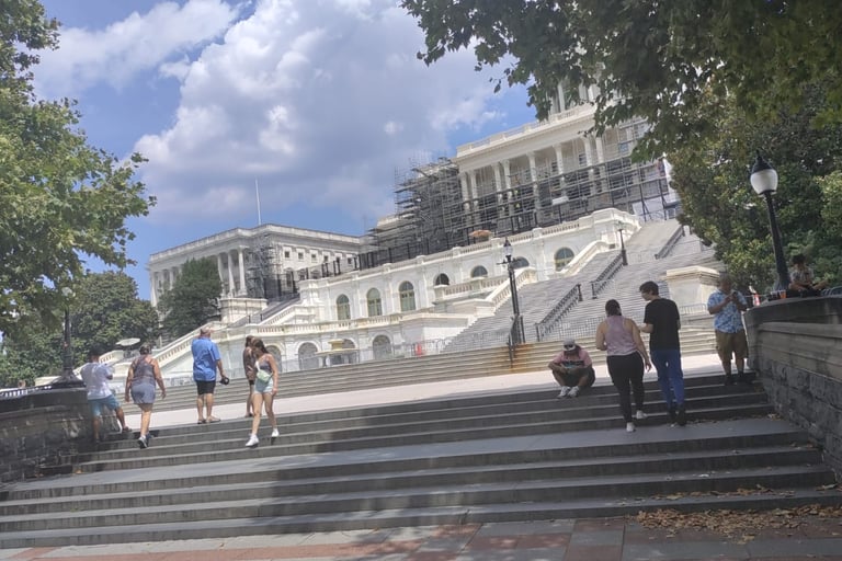a group of people walking up stairs in front of a building