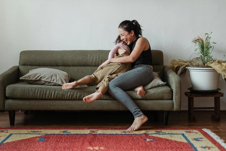 woman holding child and laughing