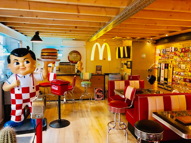 a statue of a man holding a hamburger burger king,burger king sign