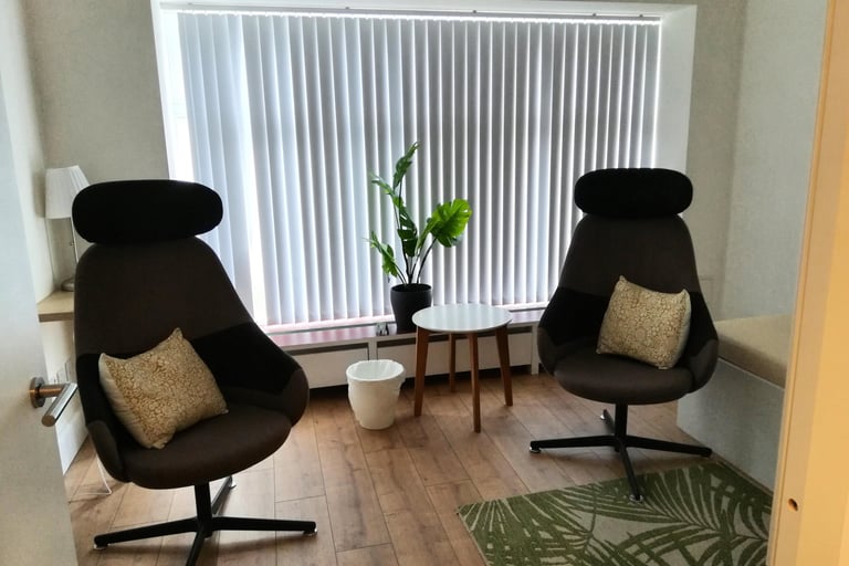 Therapy room with two chairs and a table.