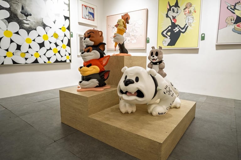 Modern pop art exhibition featuring colorful cartoon character sculptures and paintings in a gallery setting.