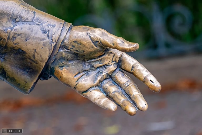 Close-up view of Ronald Reagan statue’s hand, symbolizing leadership and strength.