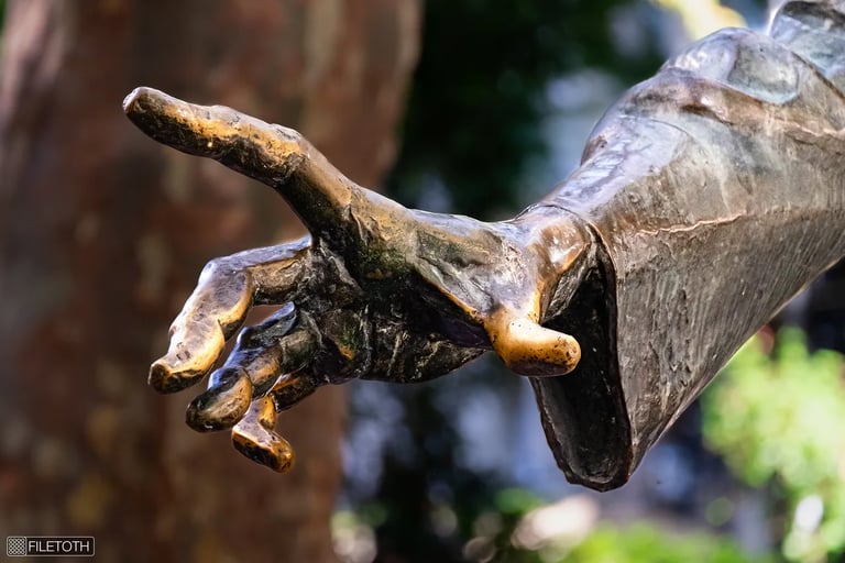 Close-up of Liszt's sculpted right hand, detailed and poised, symbolizing expressive artistry.