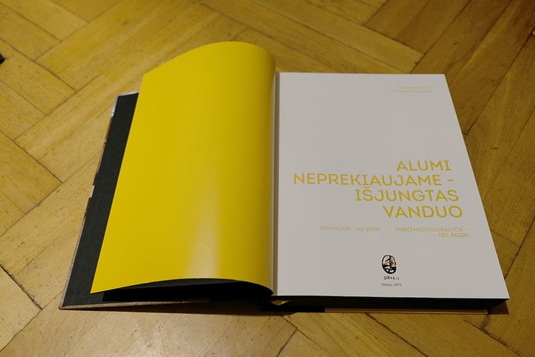 An open book. Mustard-coloured endpapers, book title.  