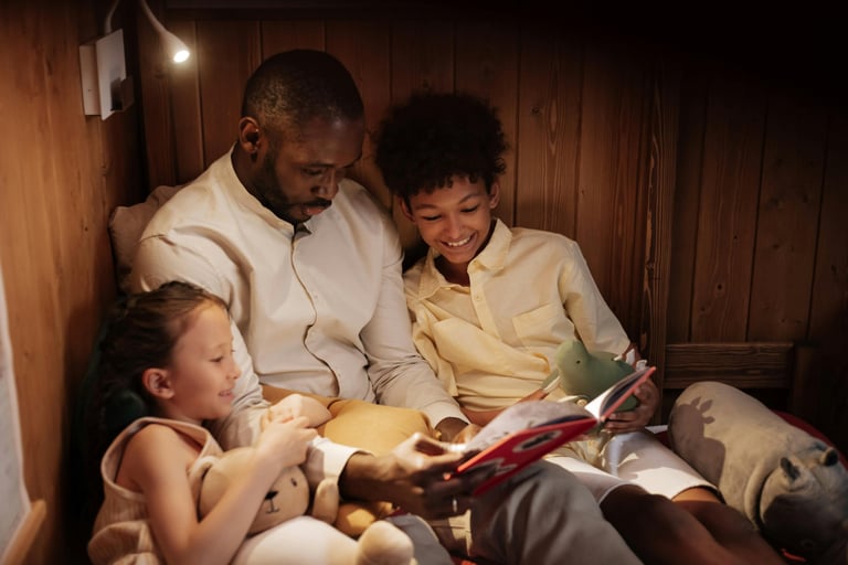 a man and two children reading a book