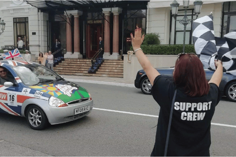 a woman waving a flag in a car