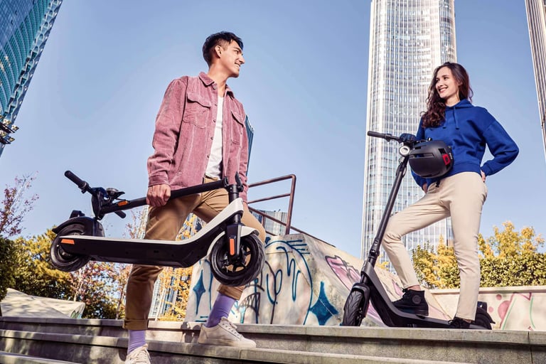 a man and woman standing on stairs with a scooter
