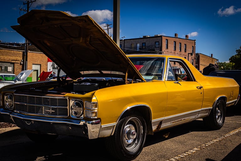 a yellow car with a hood up and a hood up