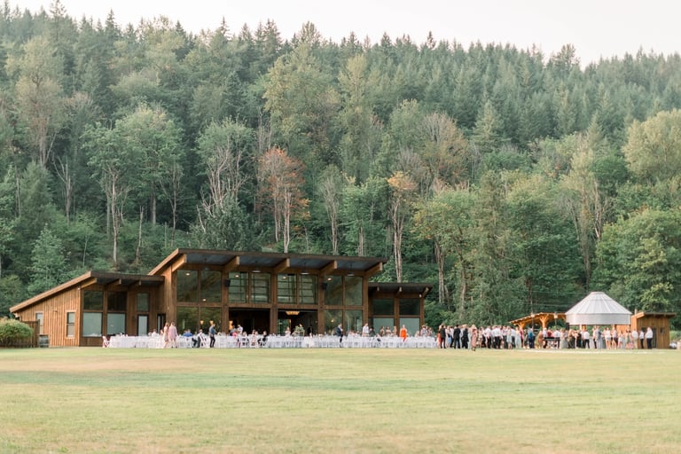 a large group of people standing around a large building