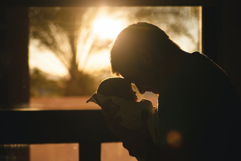 parent and baby touching foreheads