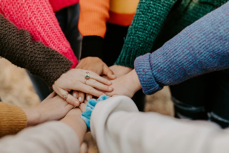 a group of people holding hands together