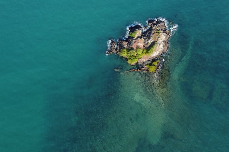 a small island with a small island in the middle of the ocean