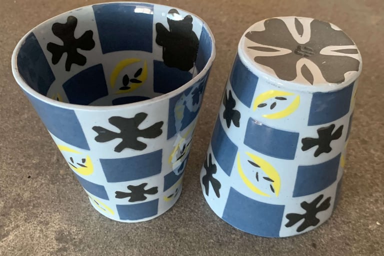Blue and black cups with patterns inside and out