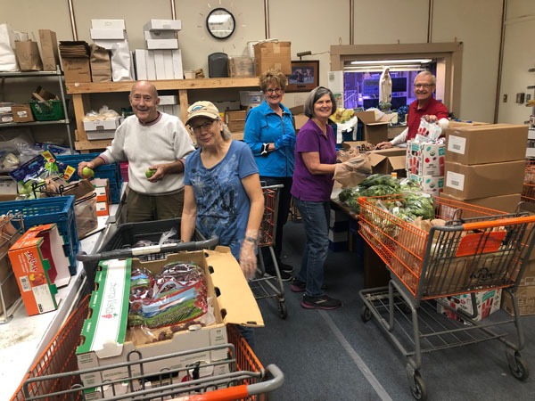 Rose Garden Volunteers sorting food donations and assembling grocery bags for neighbors