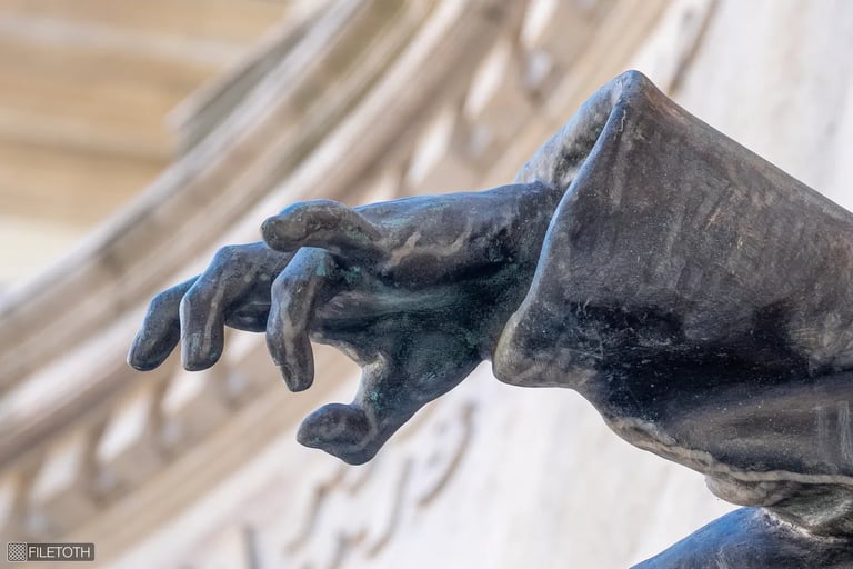 Close-up of the bronze hand of the wounded soldier from the ELTE University heroic memorial.