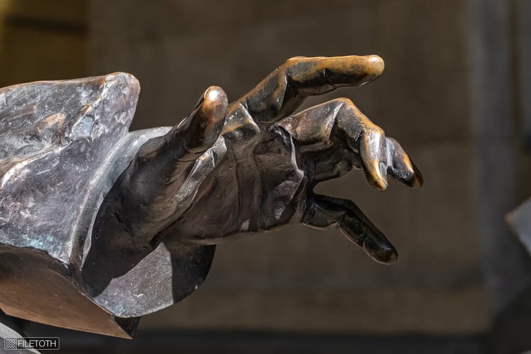 Close-up of Georg Solti statue’s hand reaching forward, symbolizing guidance and brilliance.