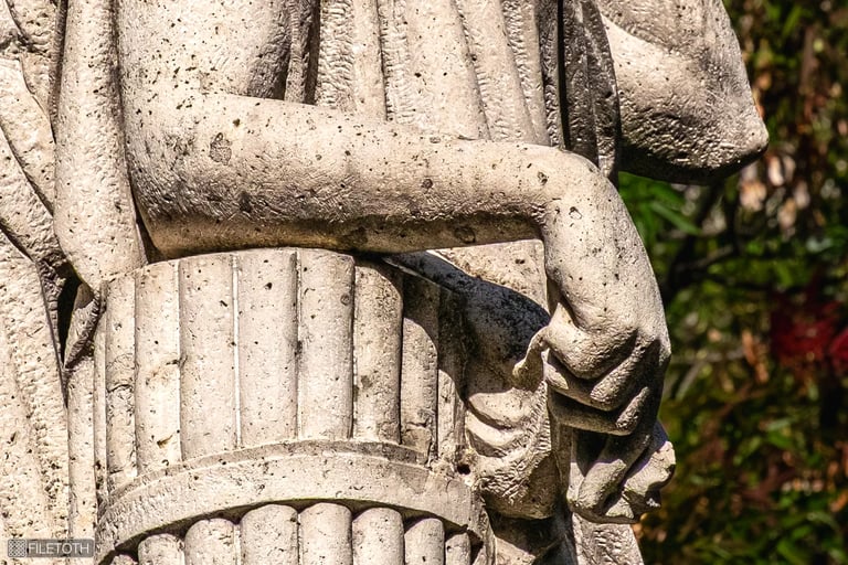 Close up on the hand of 'La Pace', fingers gently extended in a gesture of peace.