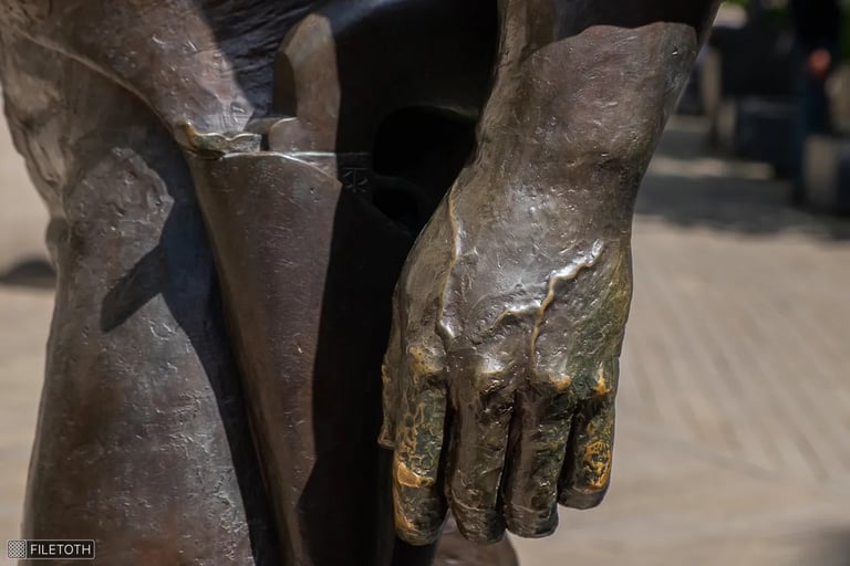 Close-up of Bud Spencer’s left hand, with a revolver visible in the holster at his waist.