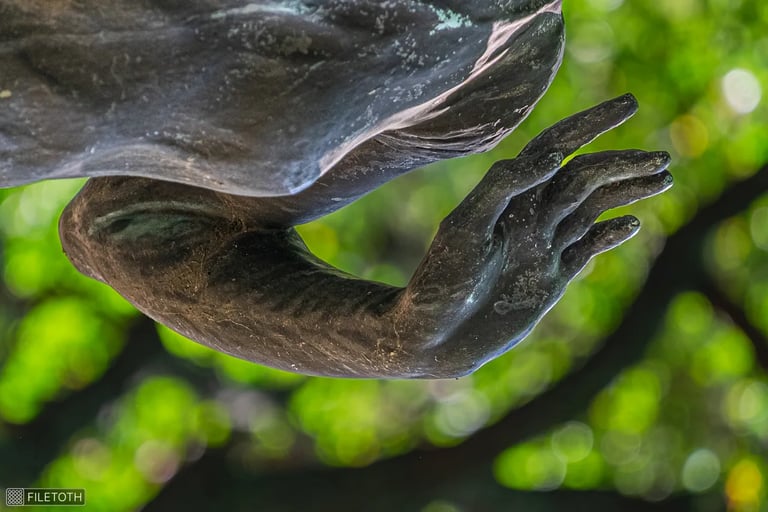 Close-up of the expressive hand, fingers poised in a welcoming spring gesture.