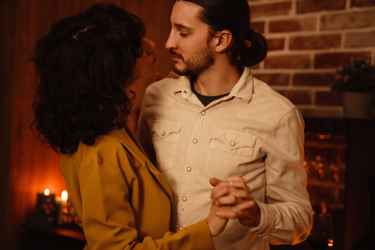 Couple dancing to romantic music with candlelight