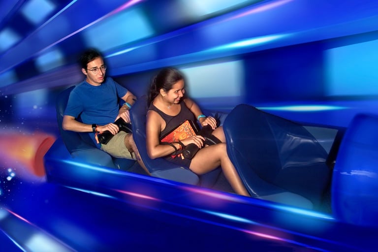 An on-ride photo of Travel Agent Andrew and his partner riding Space Mountain at Magic Kingdom.