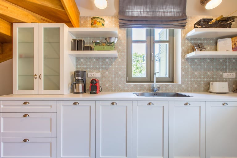 Kitchen interior with sink and window view at Villa Skyphos, Crete