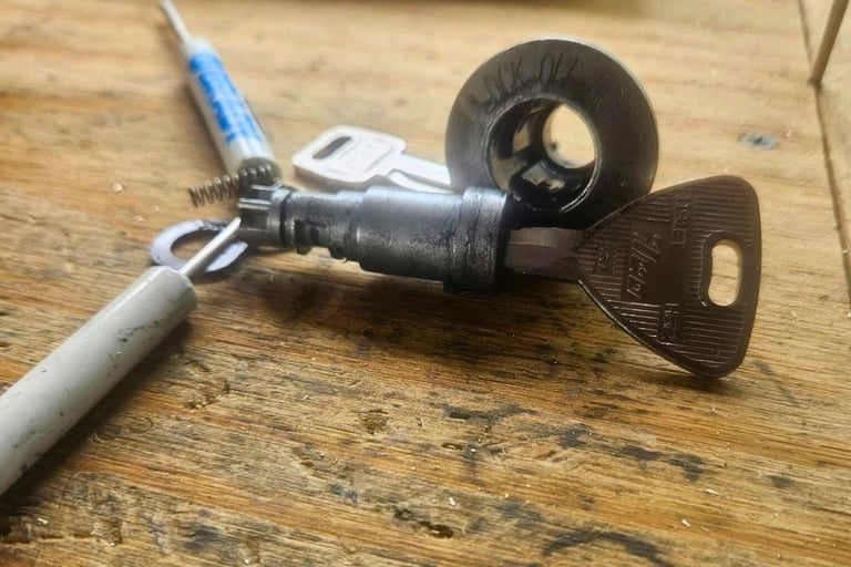 1994 Ford Escort ignition on a table being repaired representing locksmith ignition service in Fletcher, NC
