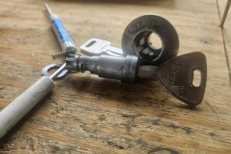 Car ignition repair service by Jack’s Locksmith in Burnsville NC showing ignition cylinder and key during repair.